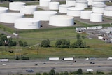 Traffic on I-95 passes oil storage tanks owned by the Colonial Pipeline Company in Linden.