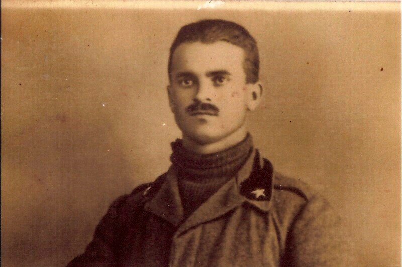 A black and white photo of a man in military uniform with short hair and a moustache.