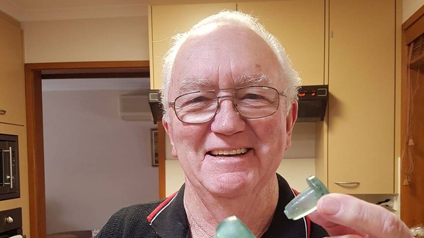 Roy Lawford poses for a photo while he puts the lid on the bottle