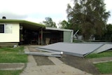 A roof lies on the footpath at Bremner Street in Blackwater.