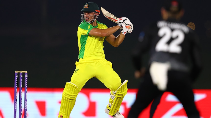 Marcus Stoinis completes a cut shot wearing the bright yellow of Australia
