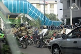 A militia bike squad make their way through the streets of the Iranian capital of Tehran
