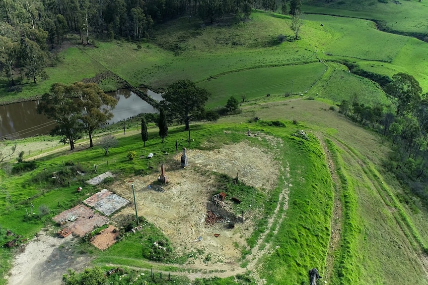 Two chimneys are all that remain of a home in a green valley