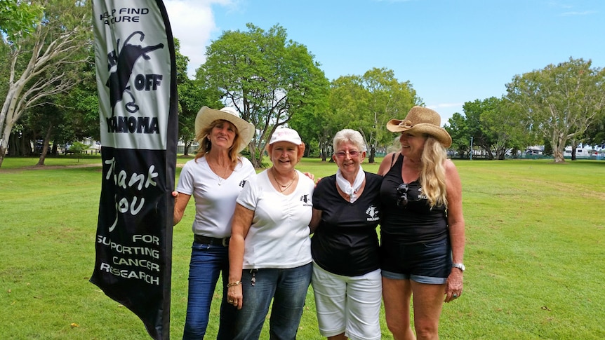 Jan Brown with buck off melanoma sign.