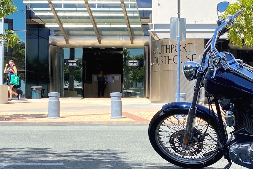 A motorbike outside a courthouse.