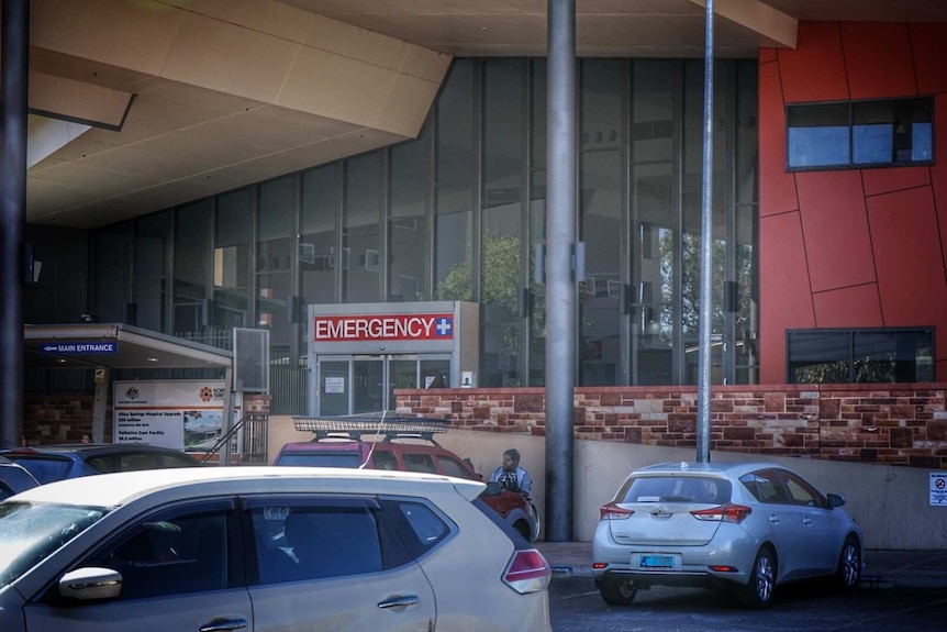 Cars are seen parked our the front of the main entrance of the Alice Springs Emergency Department.