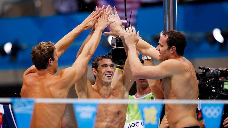 Michael Phelps, Matthew Grevers (L) and Brendan Hansen (R) celebrate the 4x100m medley relay win.