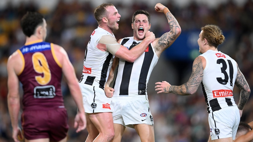 A Collingwood player pumps his fist in celebration after a goal.
