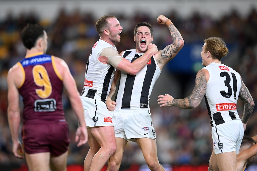 A Collingwood player pumps his fist in celebration after a goal.