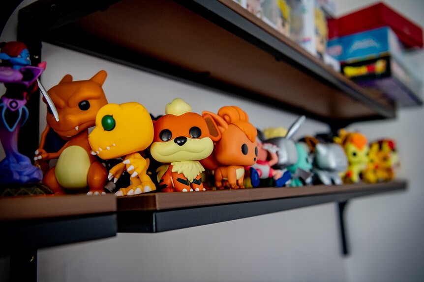 A collection of toys on a shelf.