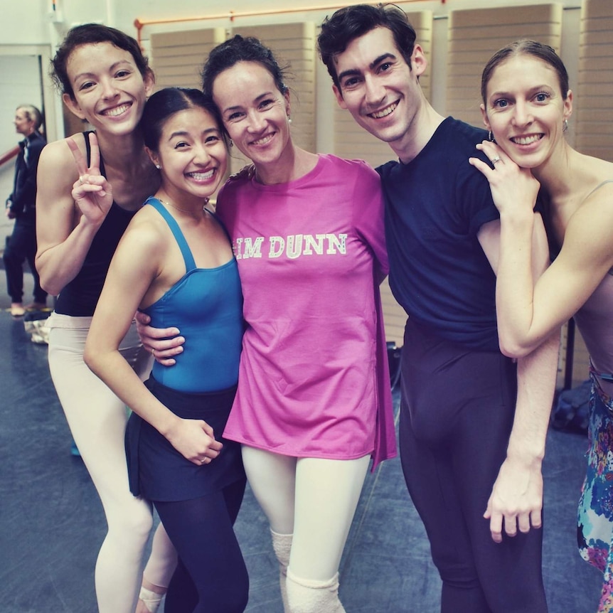Ballerina Lucinda Dunn poses for a photo with other dancers during rehearsal.