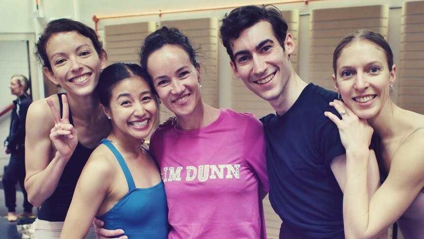Ballerina Lucinda Dunn poses for a photo with other dancers during rehearsal.