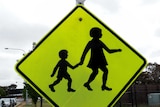 A children crossing road sign