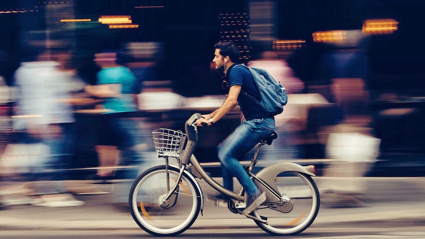 Young man on bike for a story about the benefits of not using the car