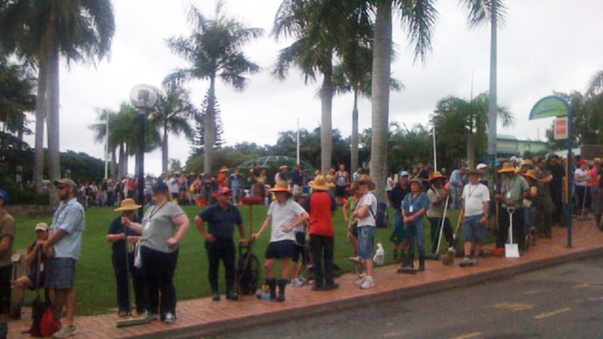 Line-up of people outside in street at the Planetarium in Brisbane waiting to register as volunteers