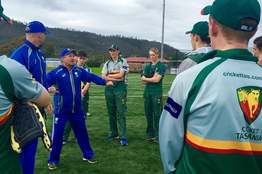 Former Tasmania cricket team coach Tim Coyle with group of cricket players.