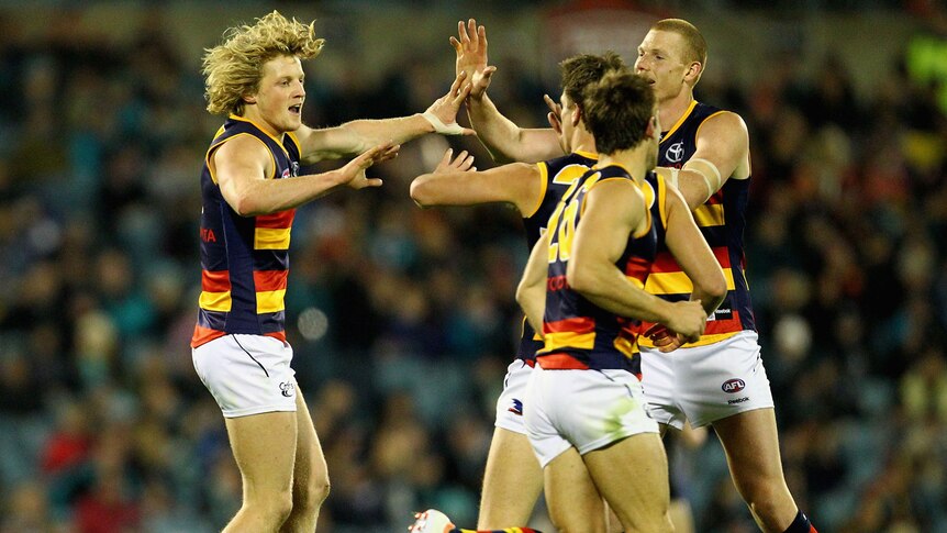 Rory Sloane and the Adelaide Crows celebrate another goal in the Showdown against Port Adelaide.
