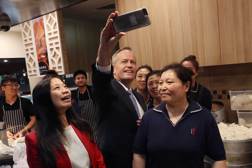 Opposition Leader Bill Shorten (centre) and Labor candidate for Chisholm Jennifer Yang (left) pose for a photograph.