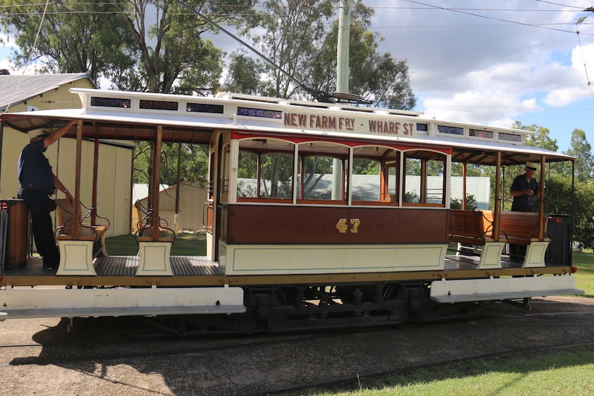 A restored tram on tracks at Tramway Museum in Ferny Grove