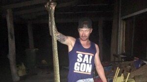 A family friend holds the 3-metre snake after it was killed.