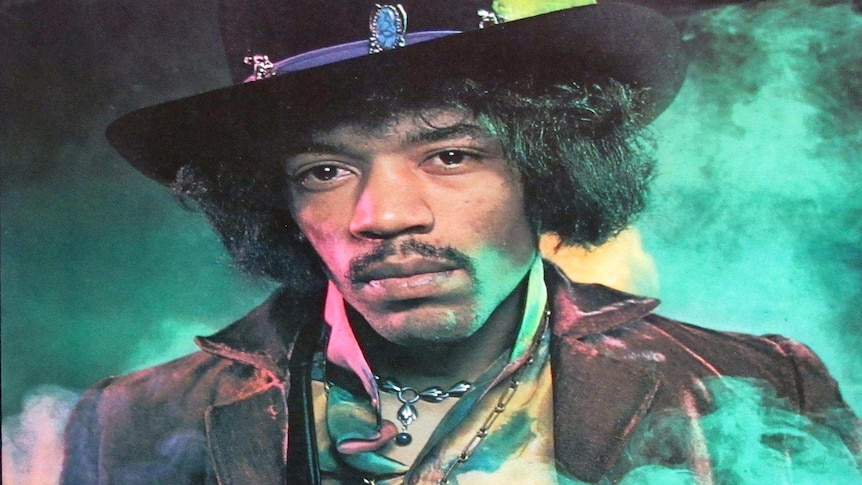 Portrait of Hendrix in elaborate dress with green smoke swirling behind