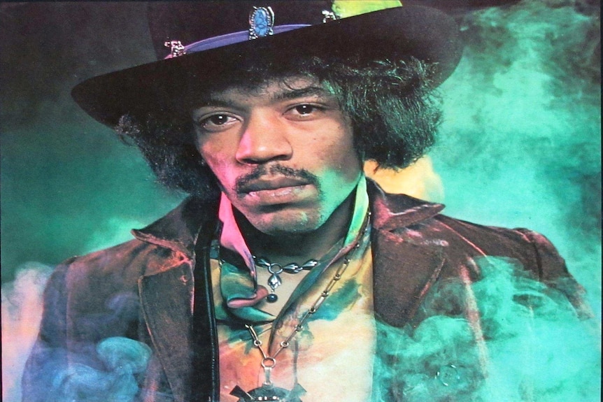 Portrait of Hendrix in elaborate dress with green smoke swirling behind