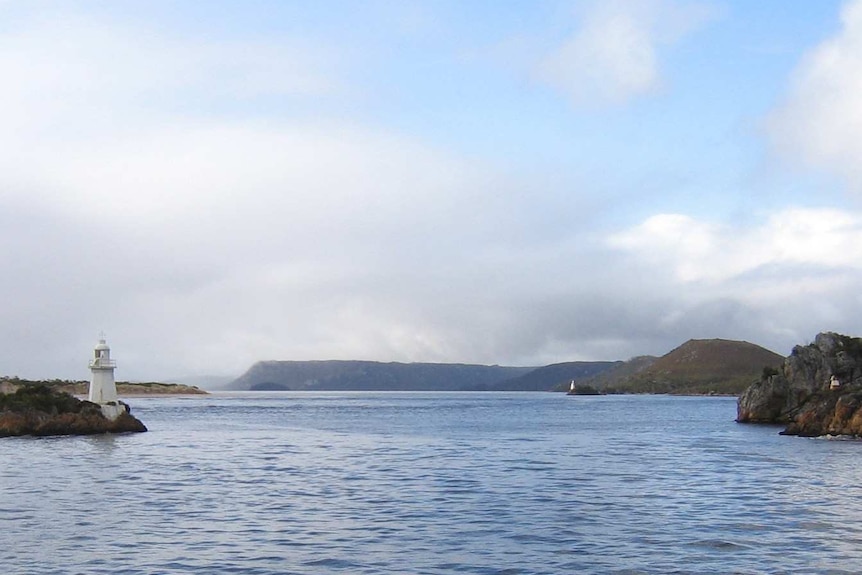 A photo of two banks of land closing in a Harbour