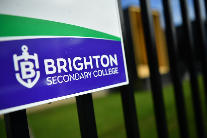 A sign on a fence that reads "Brighton Secondary College"