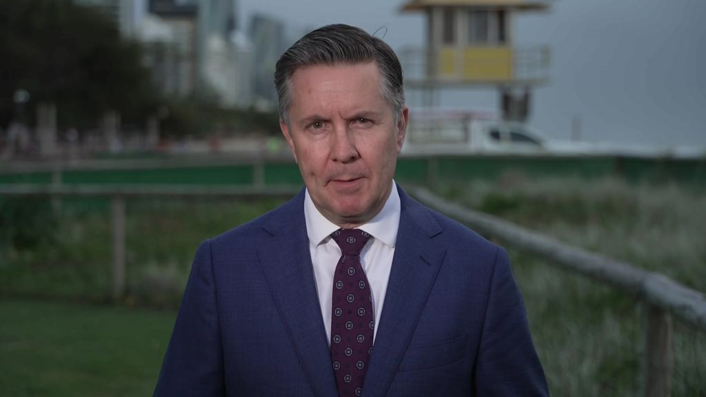 A man in a suit speaking. 