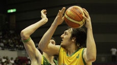 Third defeat ... Andrew Bogut drives to the hoop against Lithuania.