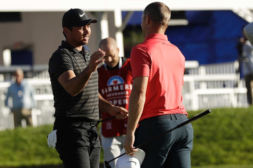 Jason Day shakes hands with Alex Noren after winning the US PGA Tour event in San Diego.