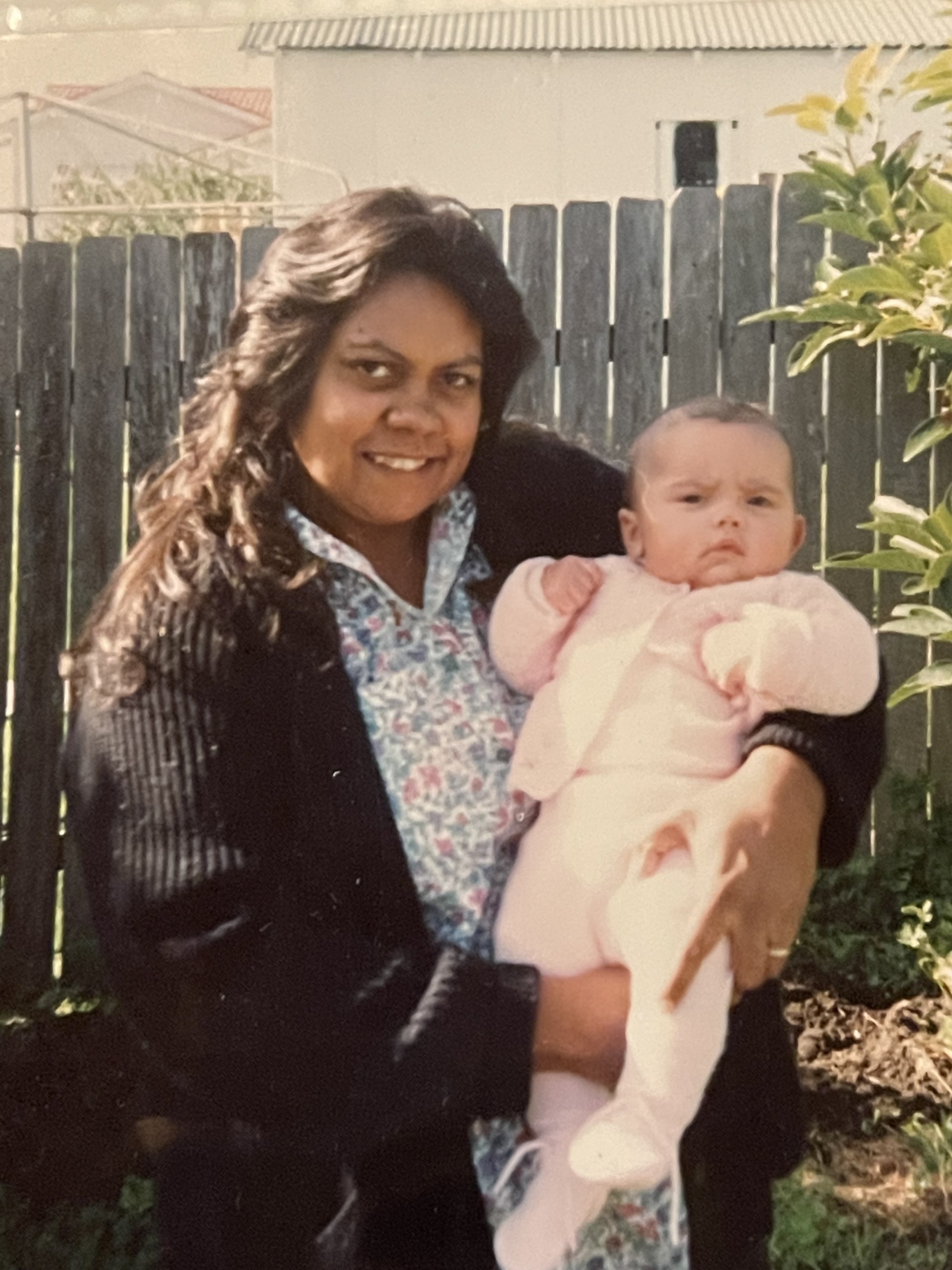 Carlie Schofield pictures as a baby, being held by her mum.