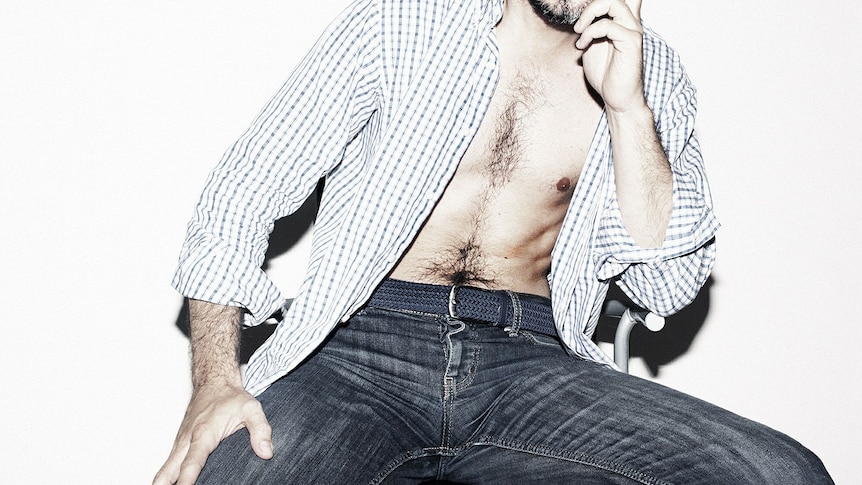 Man in jeans with shirt open, face not shown