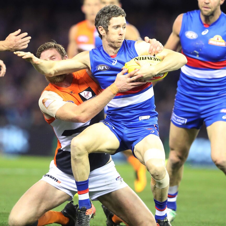 Bob Murphy tries to evade a tackle while playing against GWS.