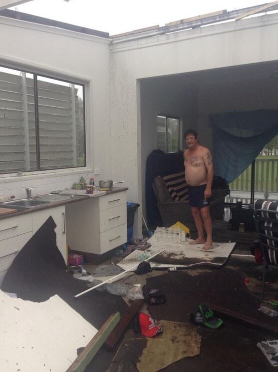 Phil Tout inside his destroyed Rockhampton home
