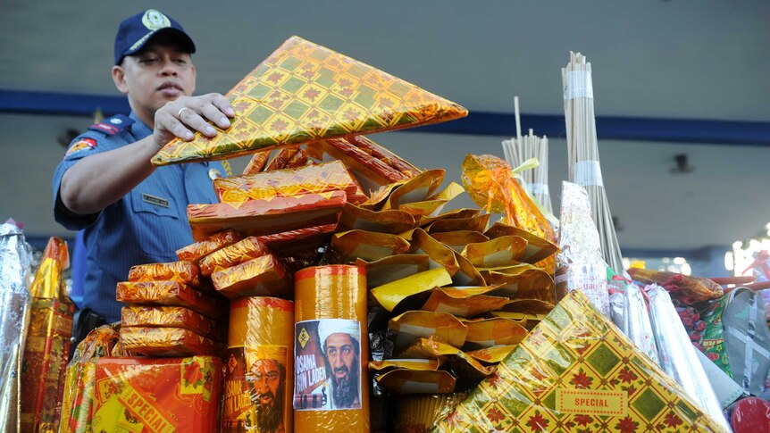 A Filipino policeman displays confiscated firecrackers
