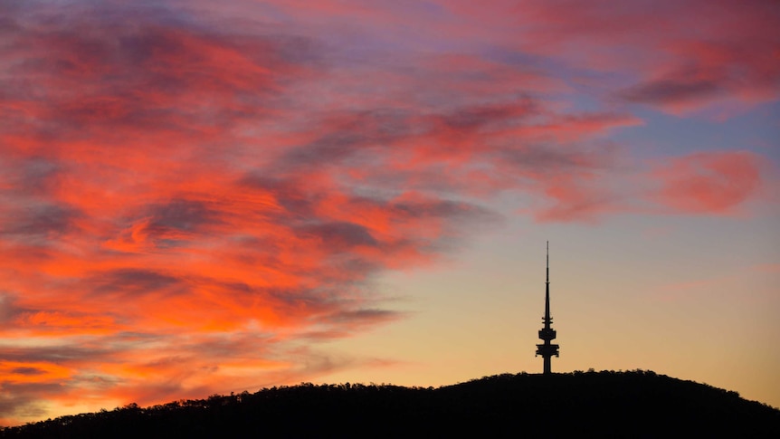 Black Mountain and Telstra Tower silhouetted against the sunset.