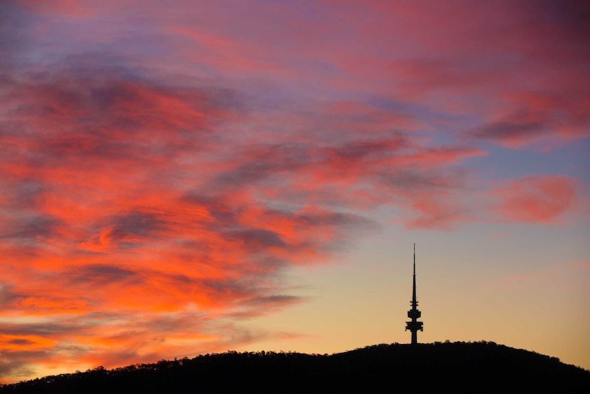 Black Mountain and Telstra Tower silhouetted against the sunset.