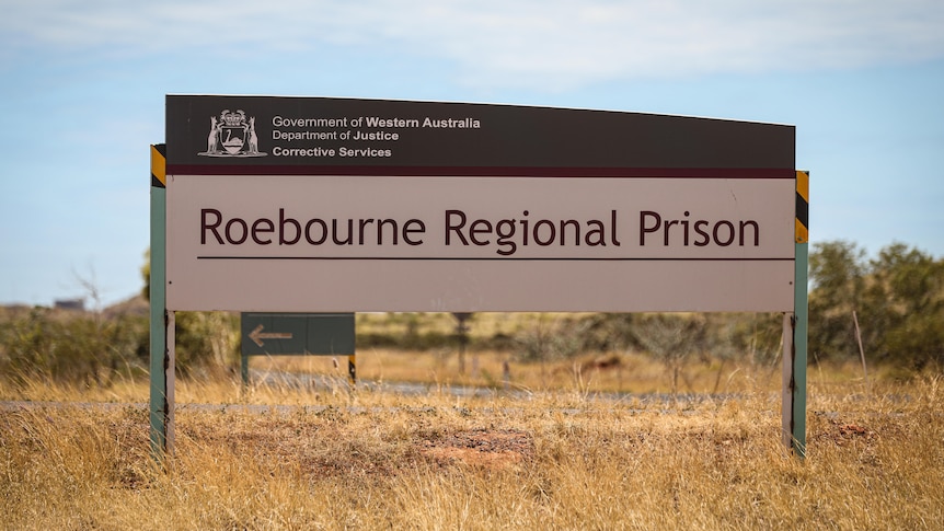 Image of a red and white sign reading Roebourne Regional Prison