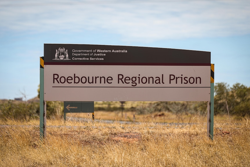 Image of a red and white sign reading Roebourne Regional Prison