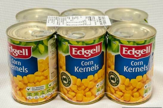 An image of a six pack of canned Edgell corn kernels, wrapped in plastic with a barcode on top