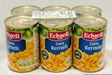 An image of a six pack of canned Edgell corn kernels, wrapped in plastic with a barcode on top