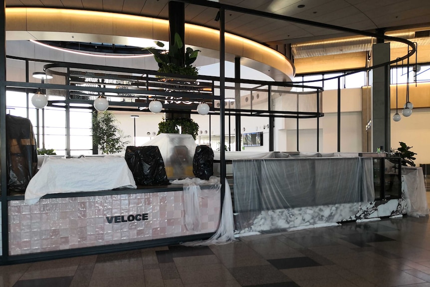 Photo of a restaurant at the airport closed and covered in draping.