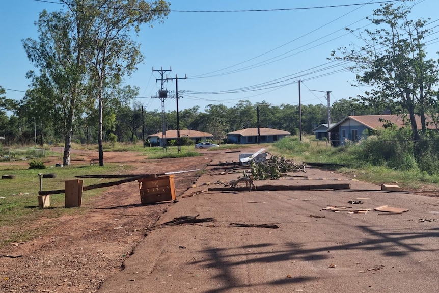 A street with debris and rubbish on the ground.