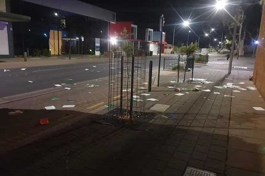 Papers scattered over a road at night 