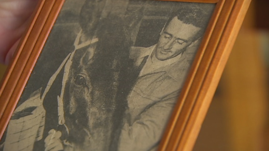 A photo of Graham Rollbusch with a horse.