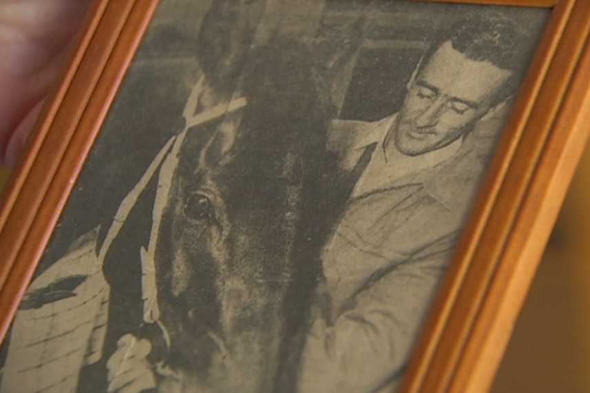 A photo of Graham Rollbusch with a horse.