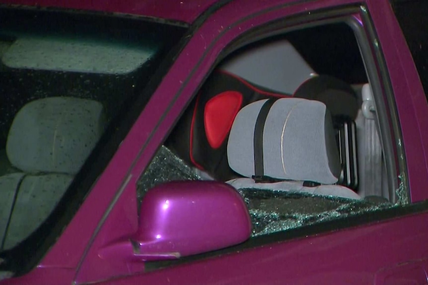 A car with its passenger window smashed.