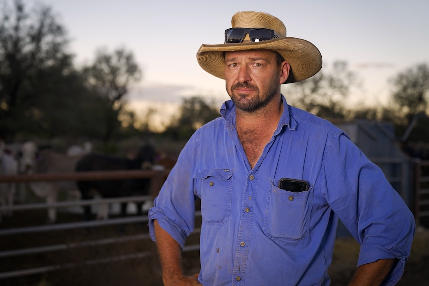 A farmer in a blue shirt and bush hat