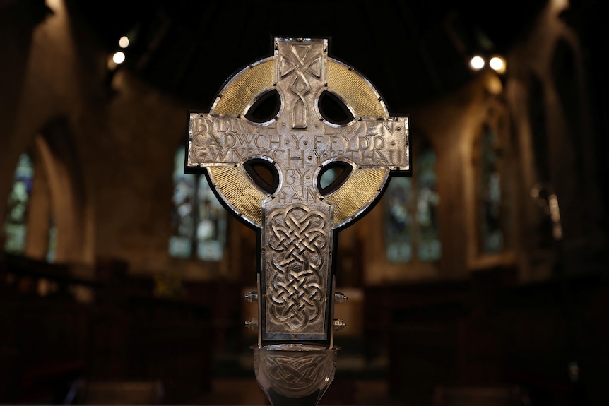 Welsh words are engraved in the silver of a cross.